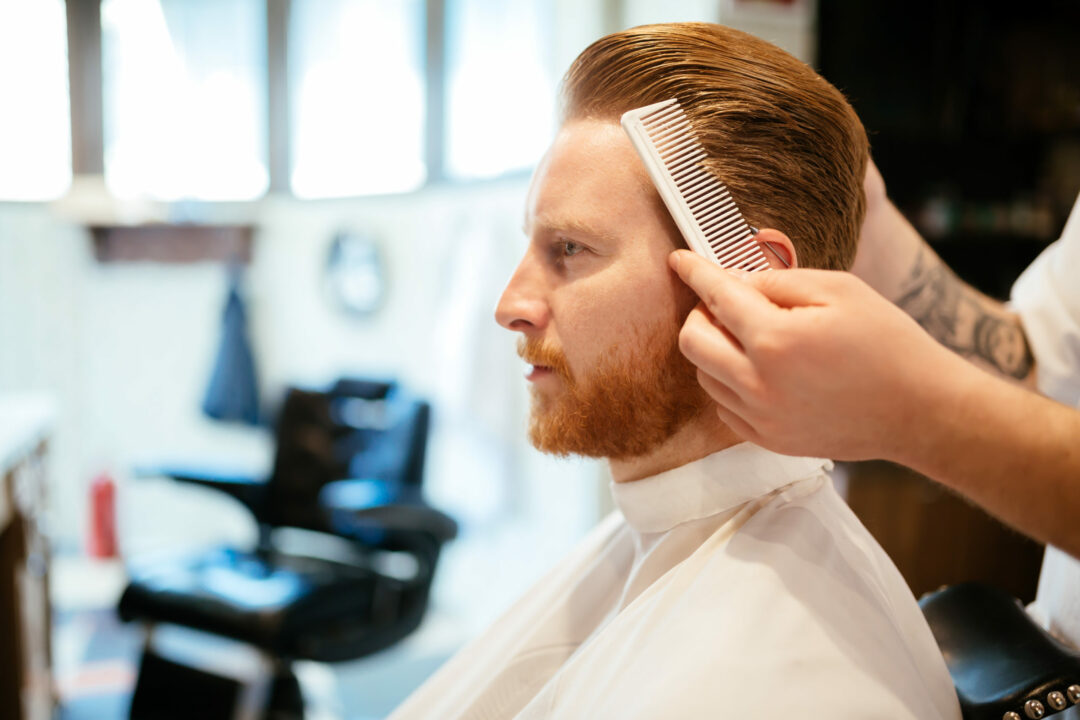 Combing of hair and styling in barber shop